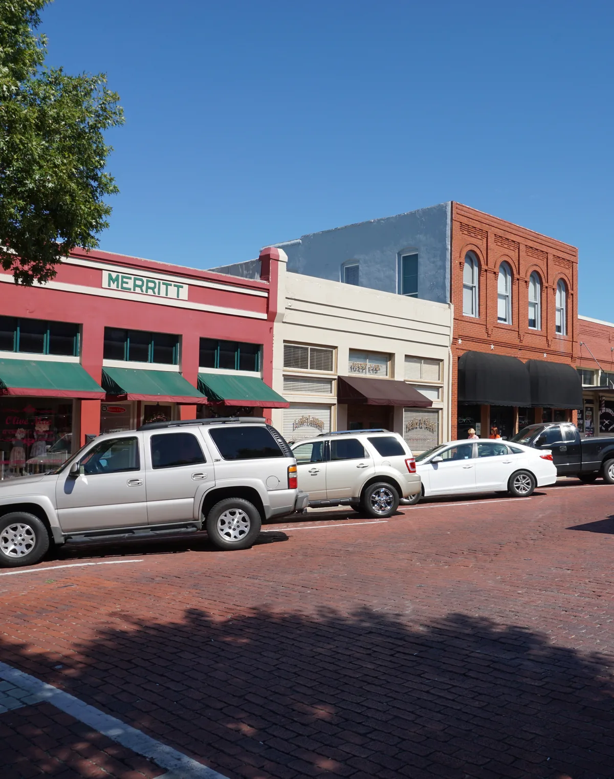Historic brick storefronts on 15th Street in downtown Plano, Texas
